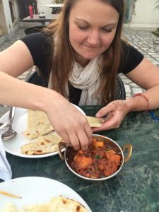 Me eating an Aloo Gobi Curry with my hands in New Delhi within The Golden Triangle of India