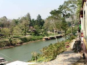 Riding the Death Railway train along the River in North Thailand
