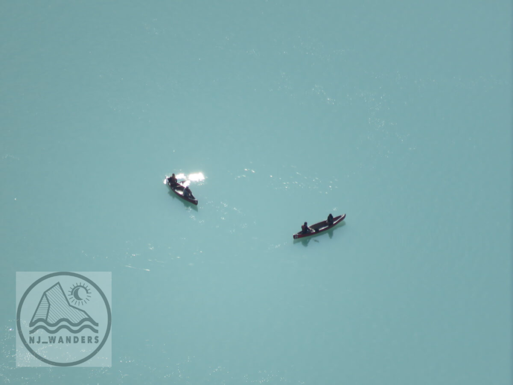 two canoes from a distance on lake louise