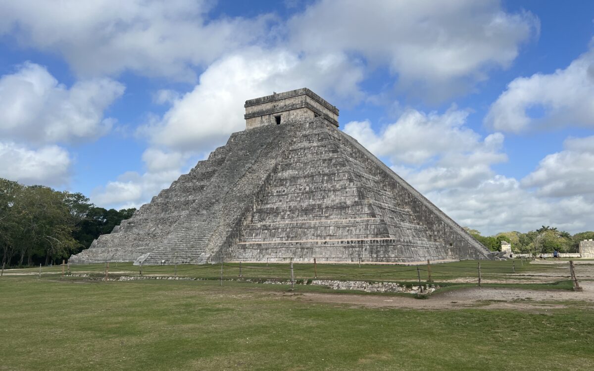 the main temple surrounded by grass and blue skies