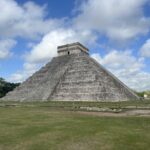 the main temple surrounded by grass and blue skies