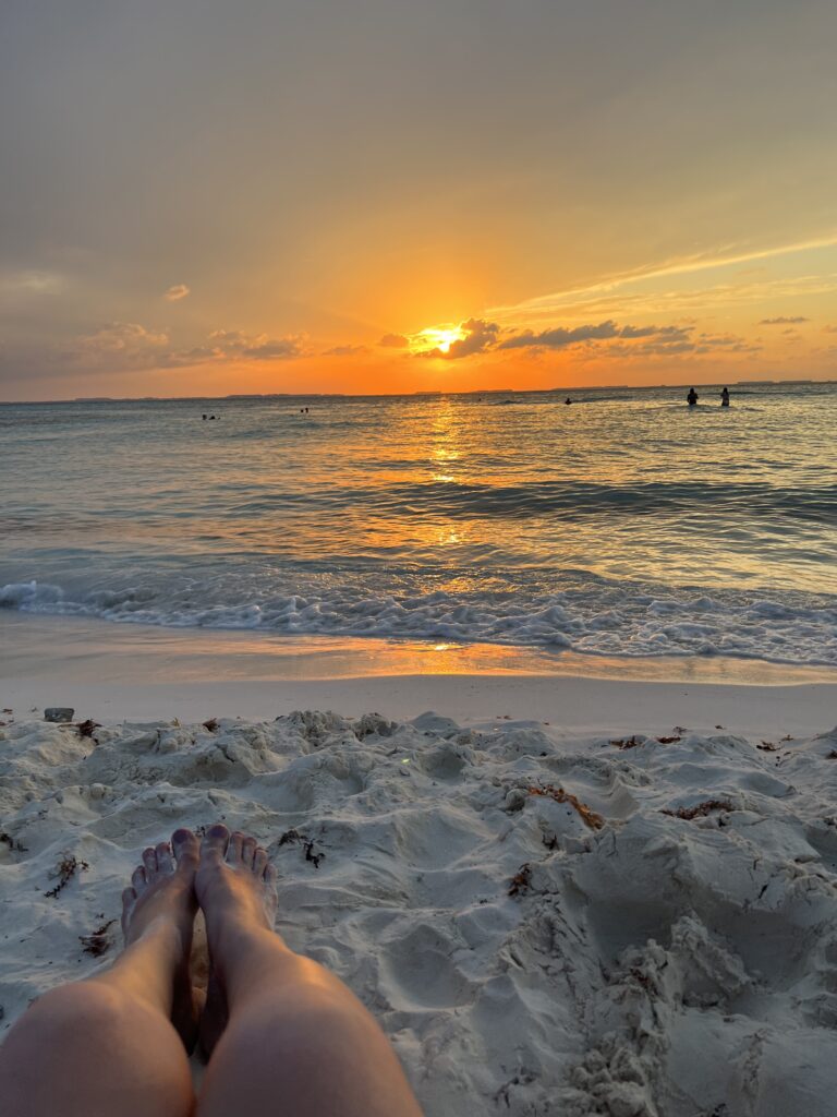 a yellow and orange sunset over the clam sea