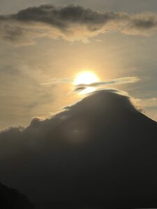 yellow circular sun over the shadow of Volcan Conception whilst backpacking Nicaragua